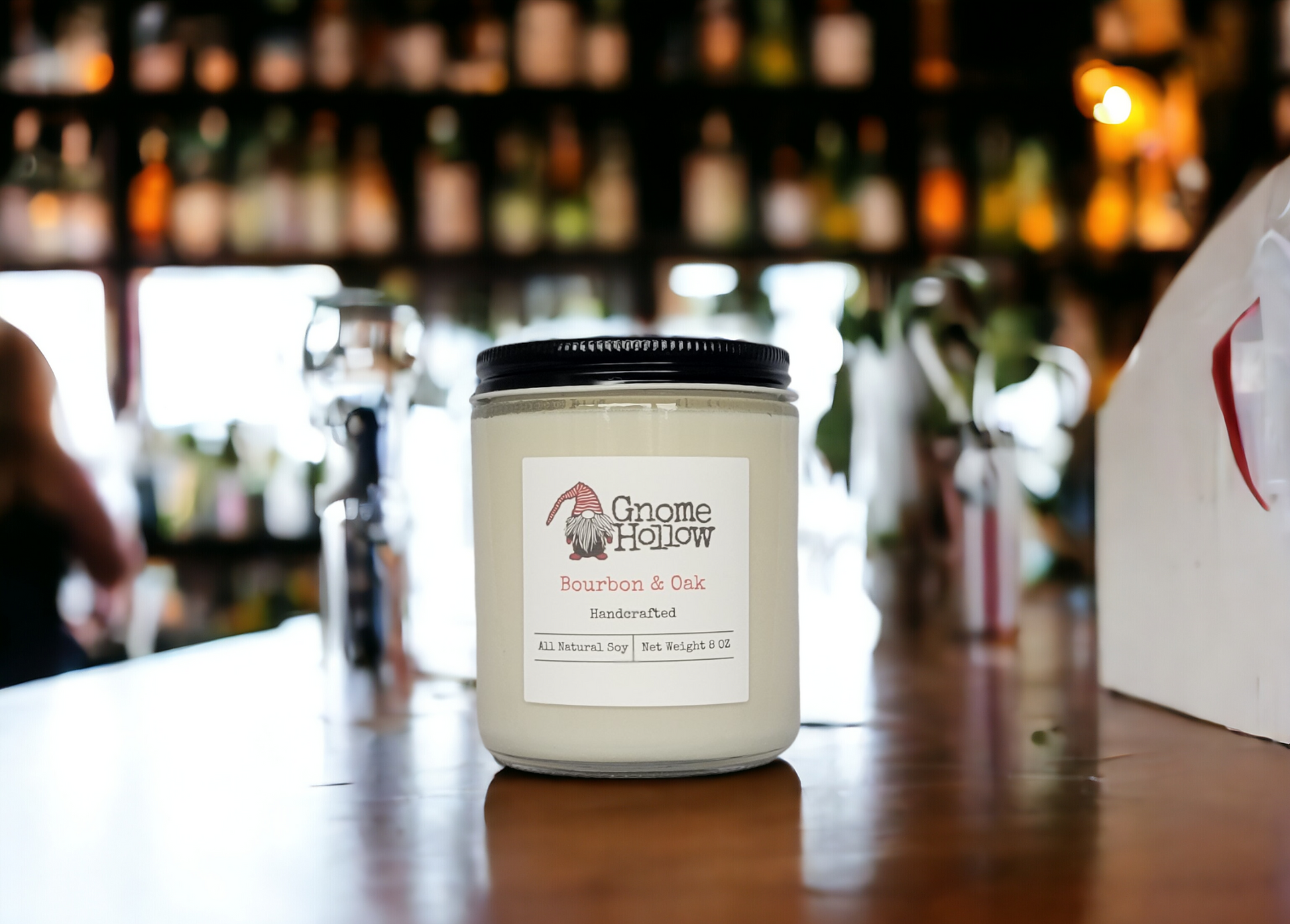 Bourbon + Oak candle sitting on a bar with a blurred background