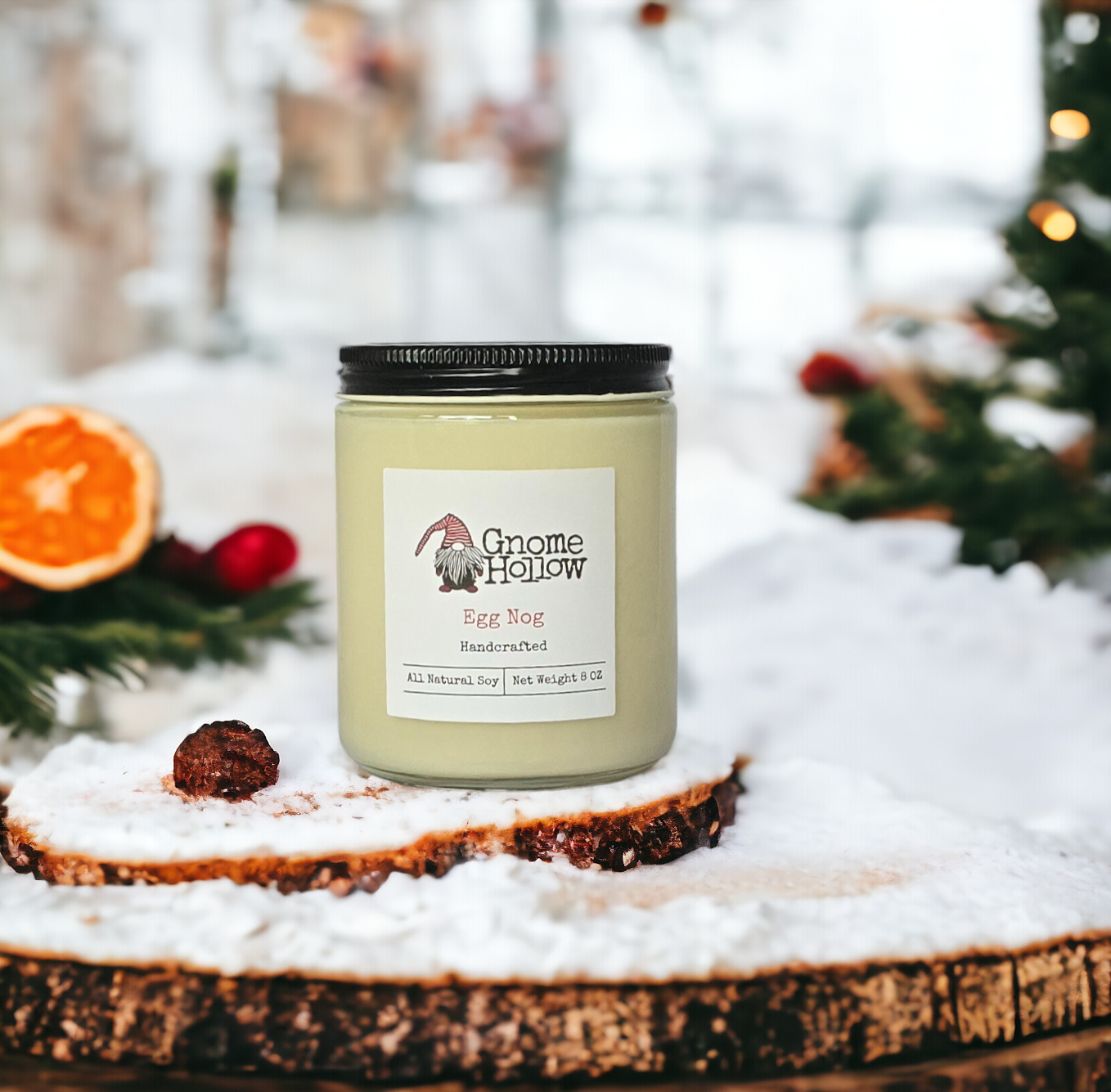 Egg Nog candles sitting on a snow covered stump with a blurred holiday scene in the background