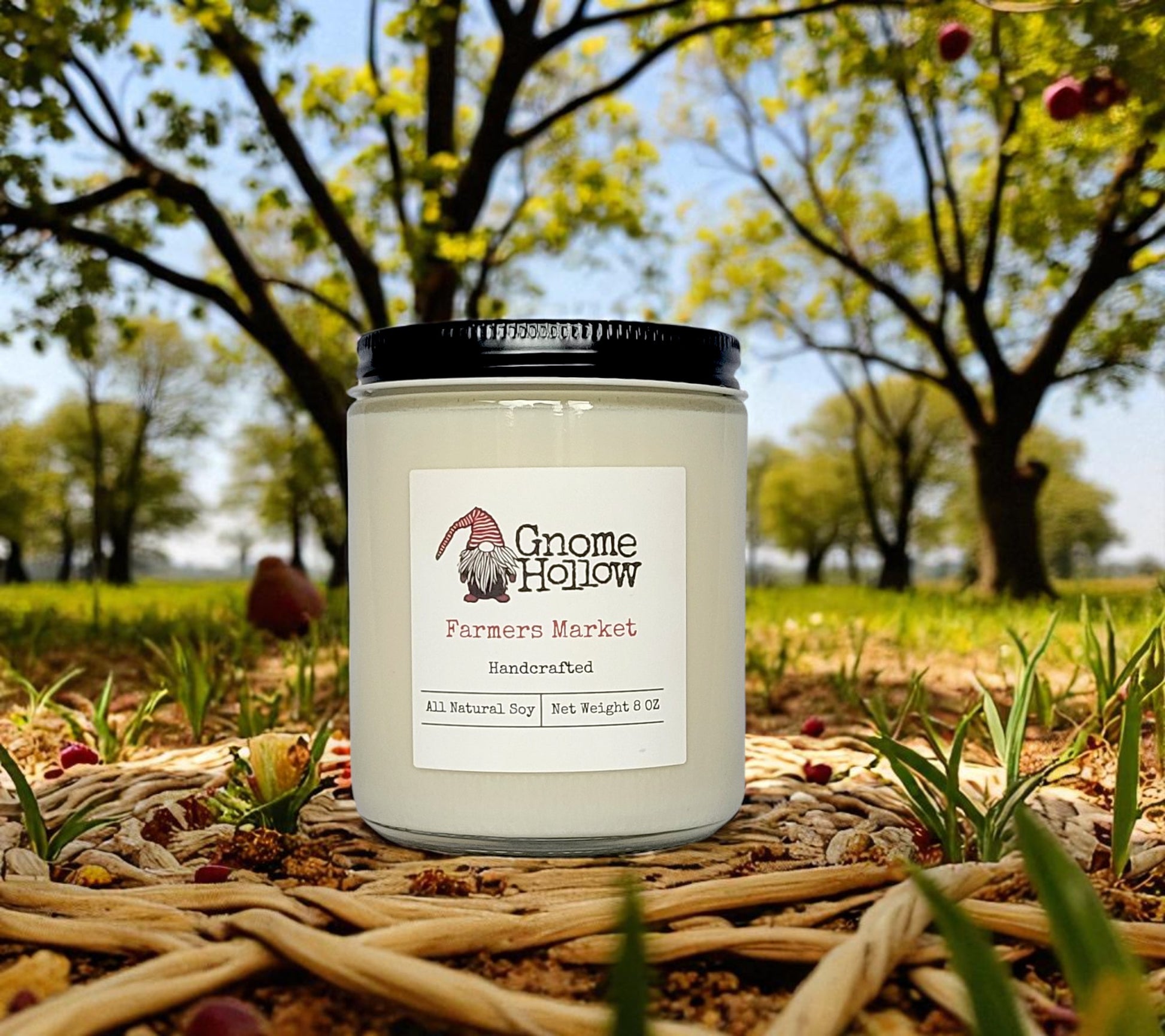 Farmers Market candle sitting in twigs amongst an apple orchard