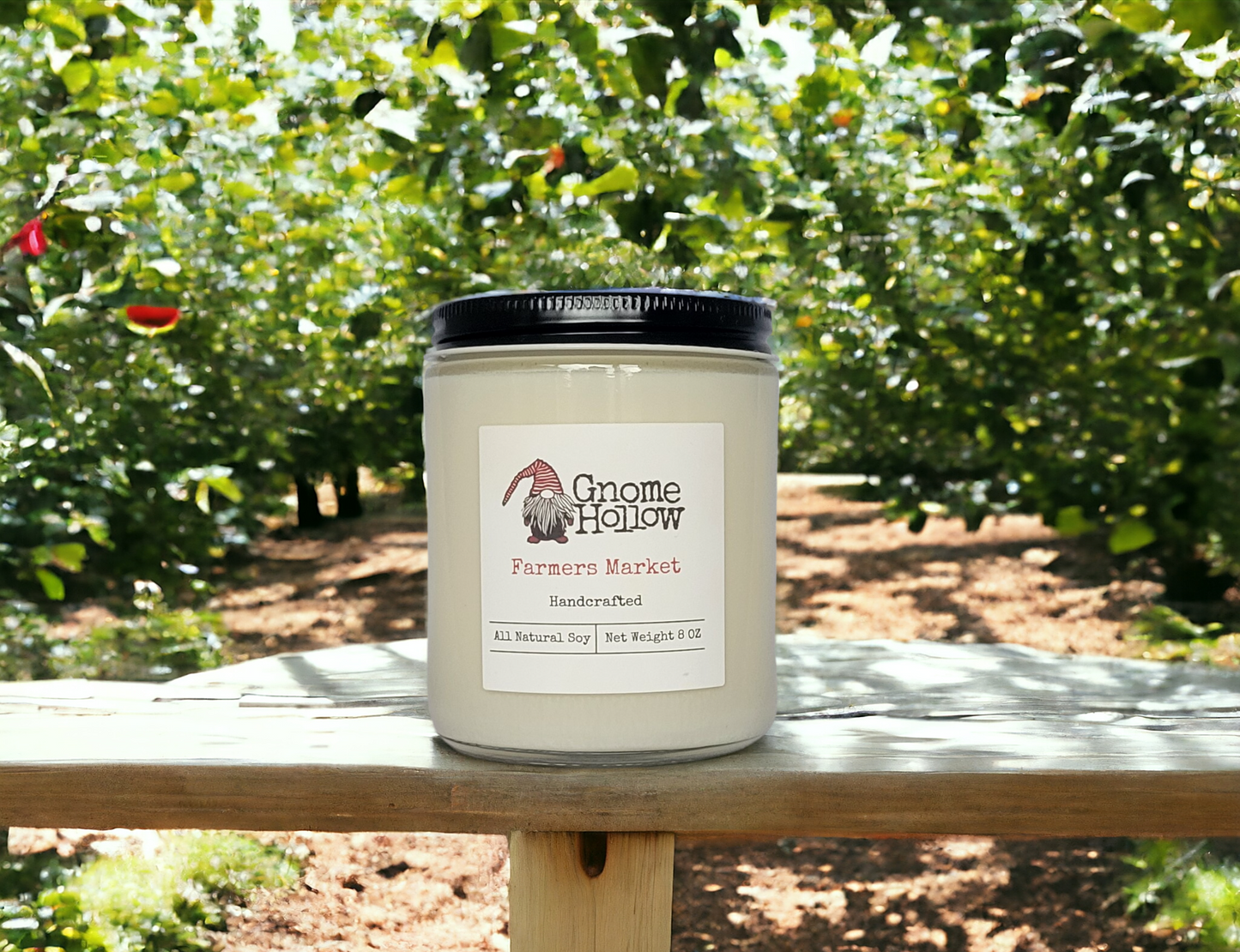 Farmers Market candle sitting on a wood bench in an apple orchard