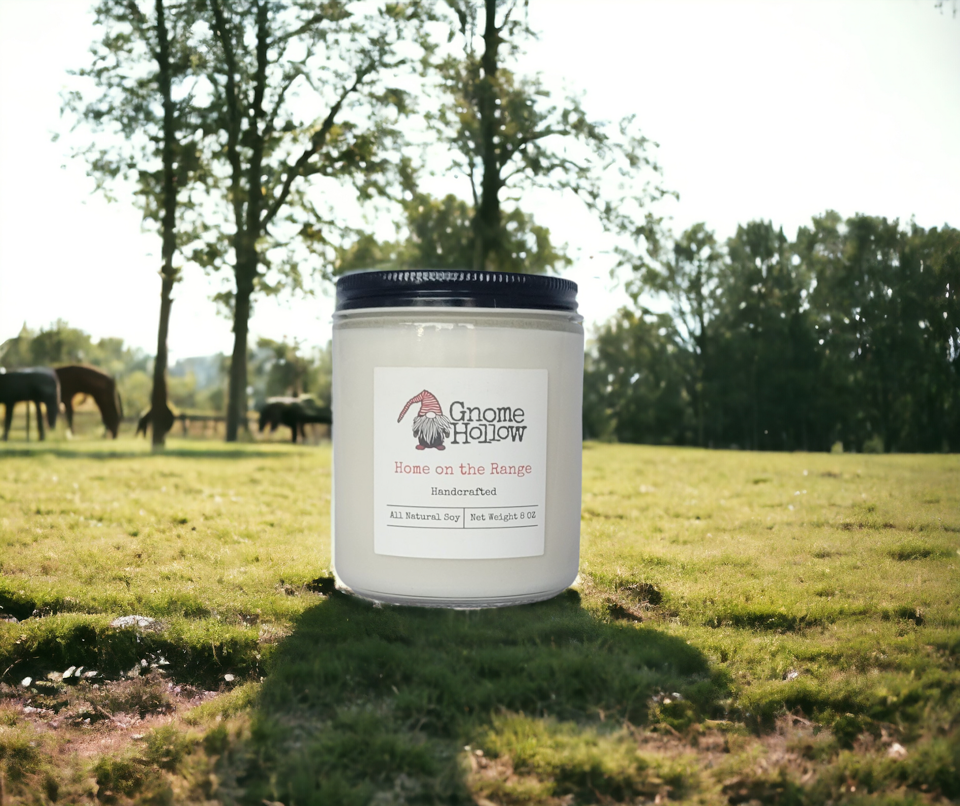 Home on the Range candle in a field with horses in the background