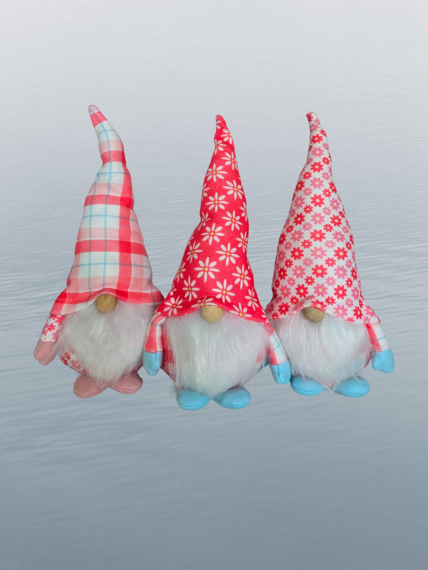 3 gnomes with white beards and coral & white hats