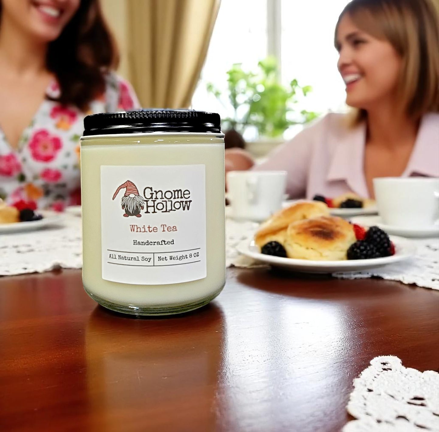 White Tea candle on a table with people in the background