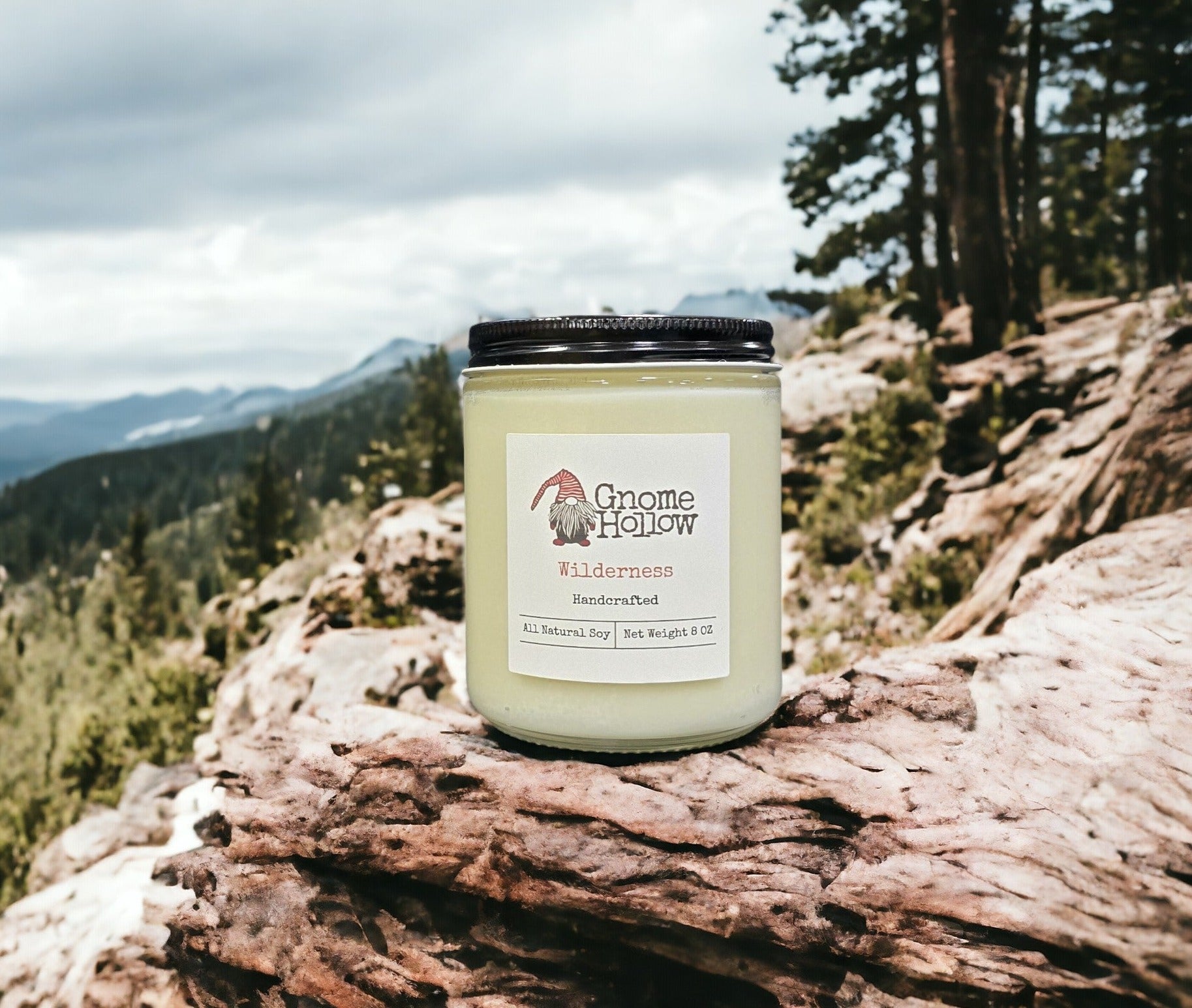 Wilderness candle sitting on a mountain with a blurred backdrop