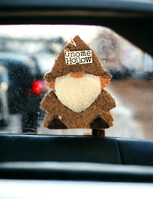 Leather gnome air freshener hanging from a rear view mirror