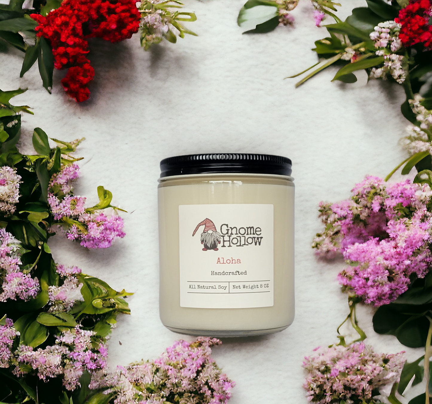 ALoha candle surrounded by colorful flowers