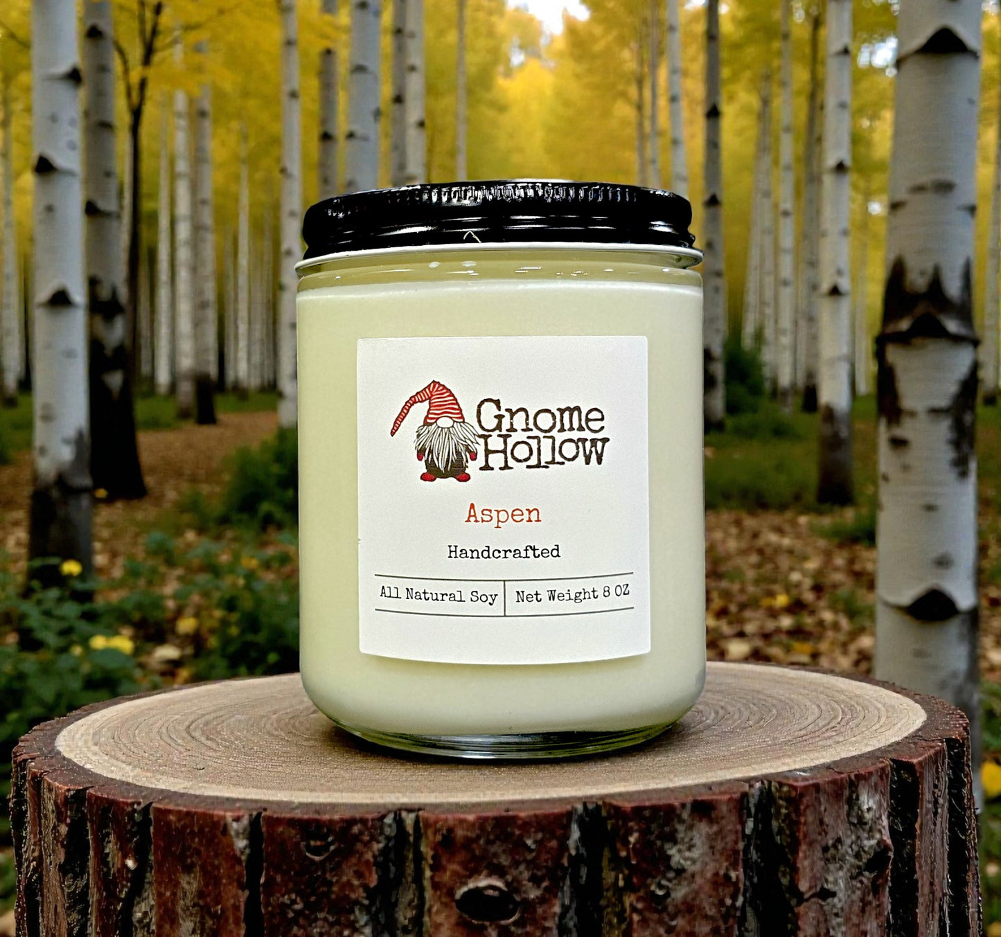 Candle in front of pine trees