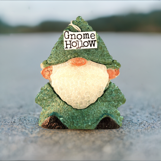 Gnome Hollow Air Freshener. Green handing gnome with a white beard and Gnome Hollow on his hat. Grey & green background