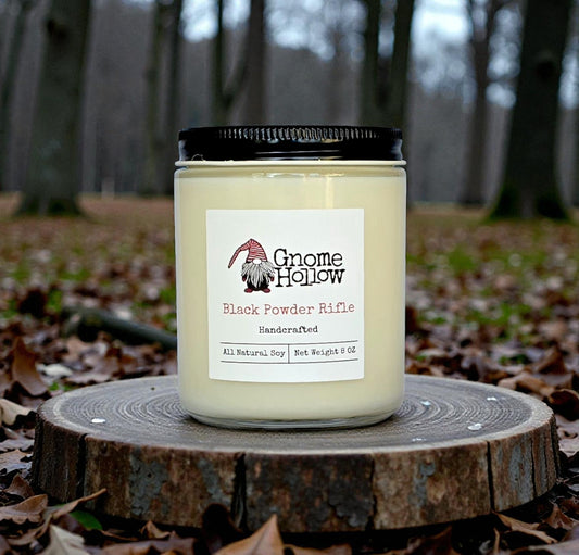 Candle in front of woods