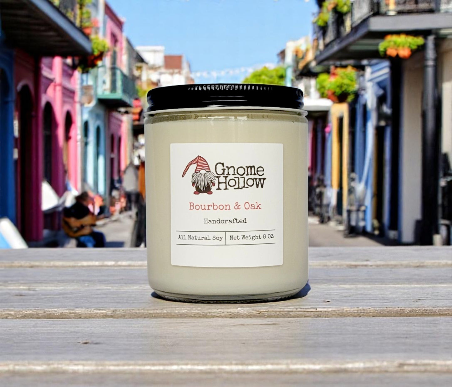 Bourbon & Oak candle placed on a table with a street scene in the background.