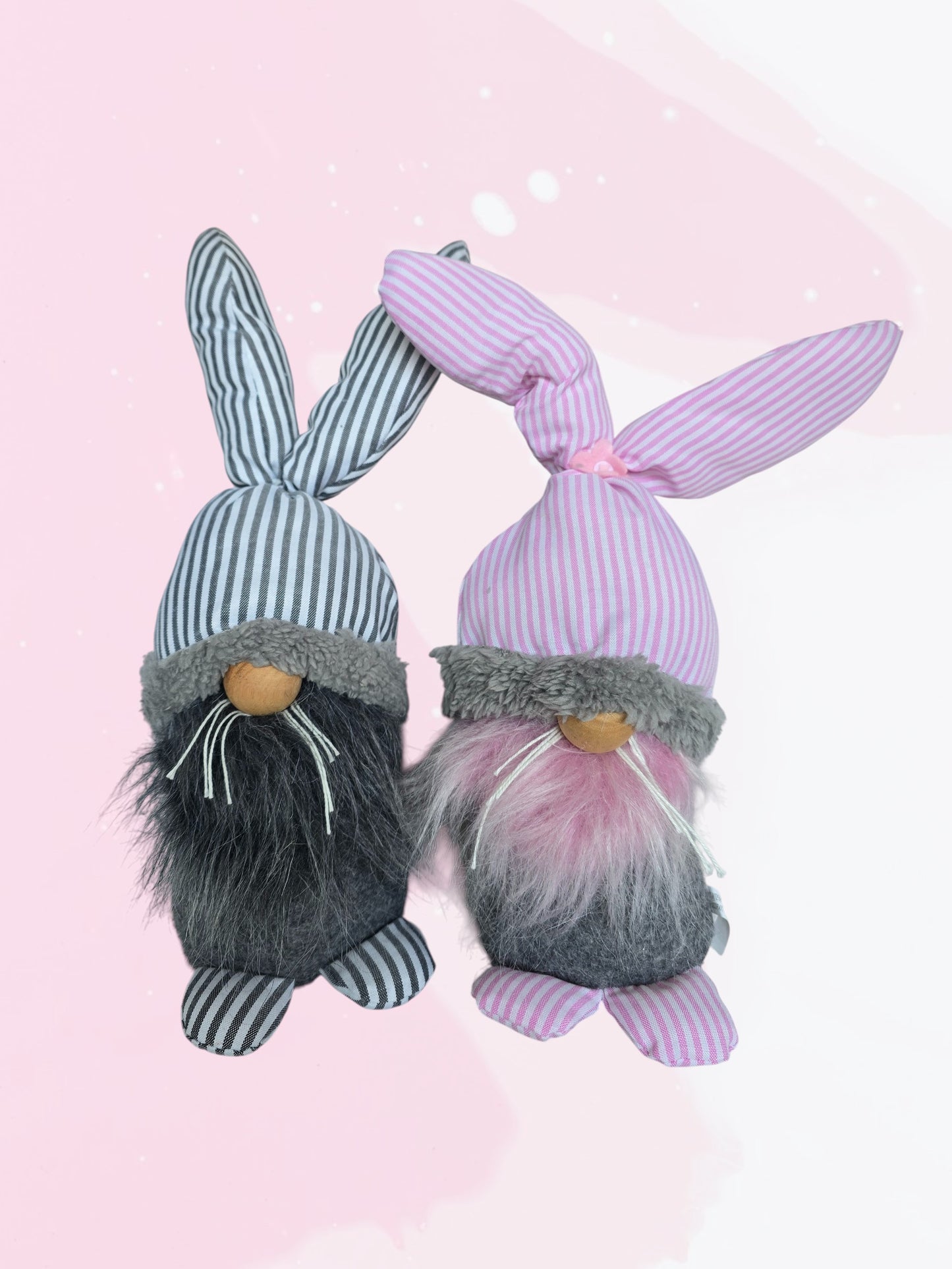 Two bunny gnomes with bunny ears on a pink background