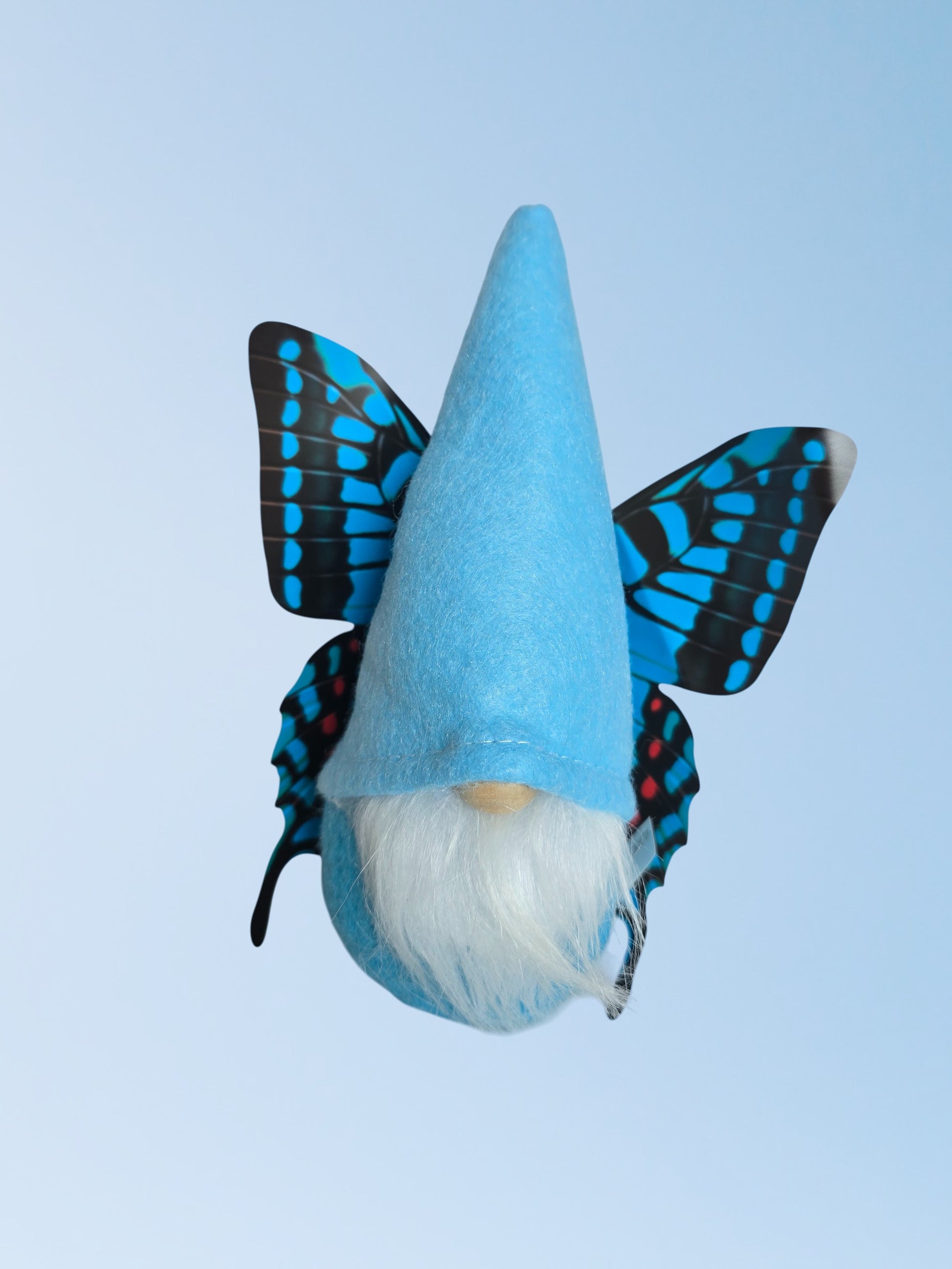 Blue gnome with a white beard and butterfly wings