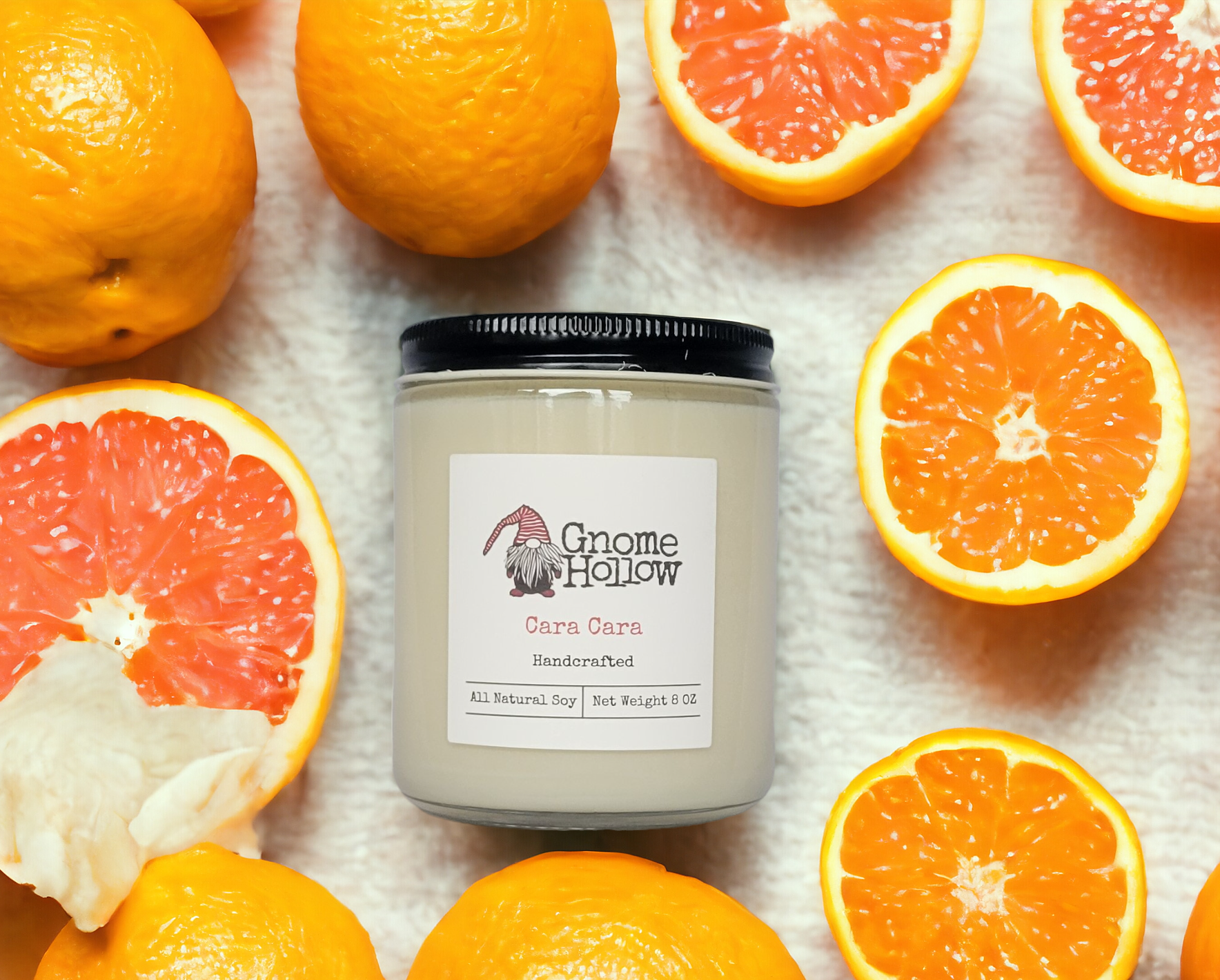 Cara Cara candle laying on its side with orange slices surrounding it