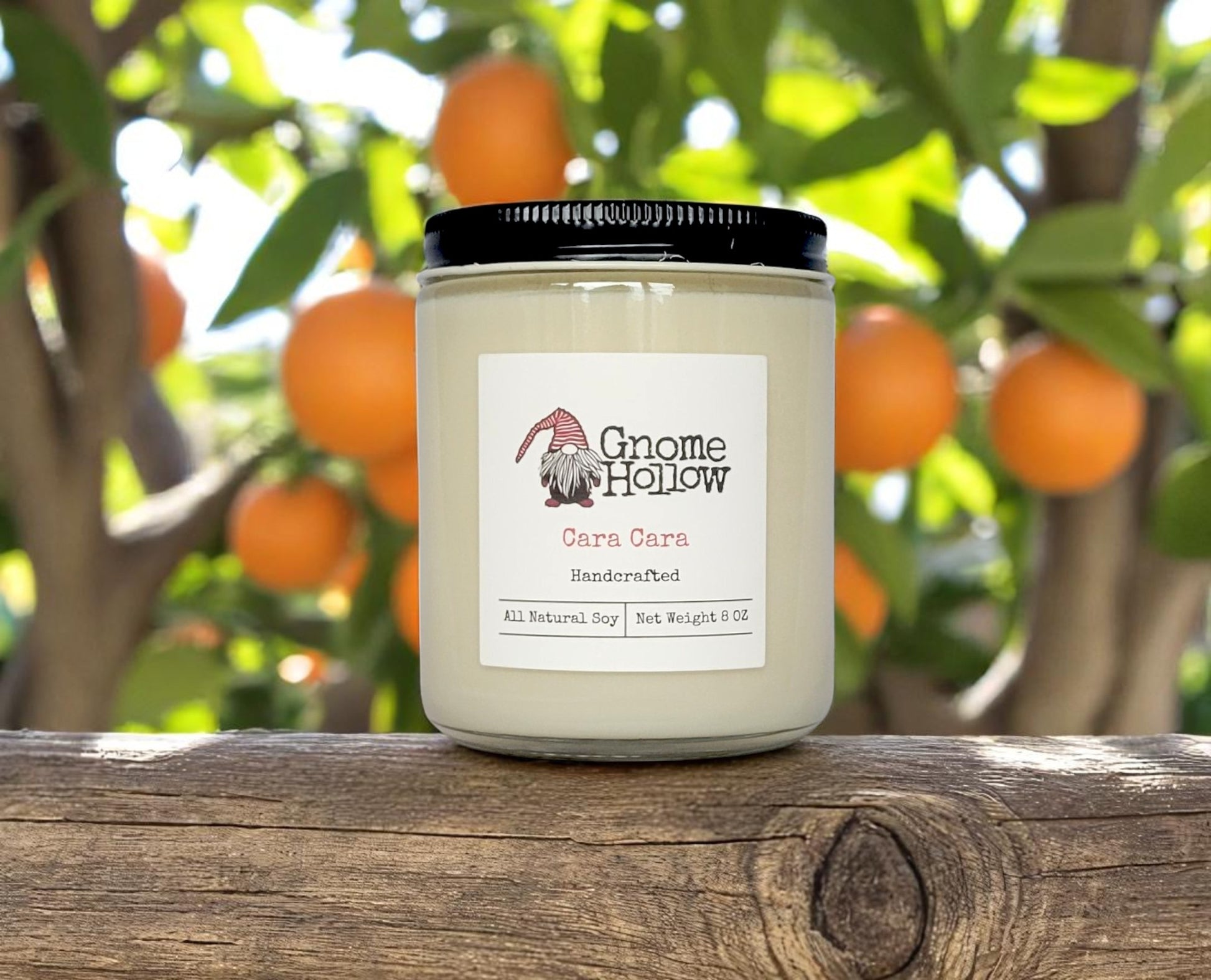 Cara Cara candles placed on a wooden surface with citrus fruits in the background.