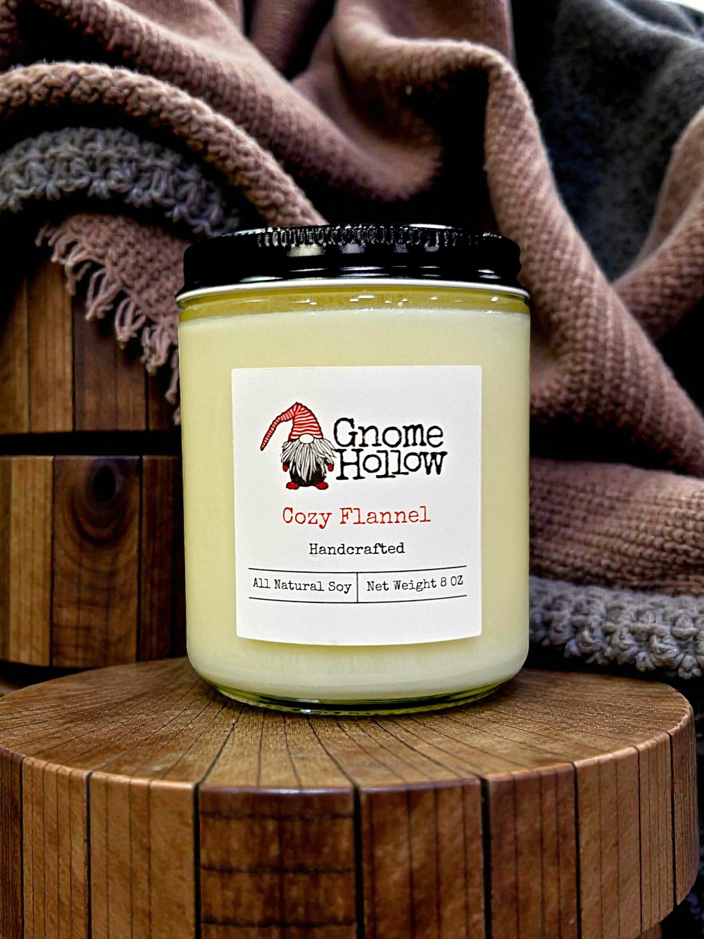 Candle in front of blankets