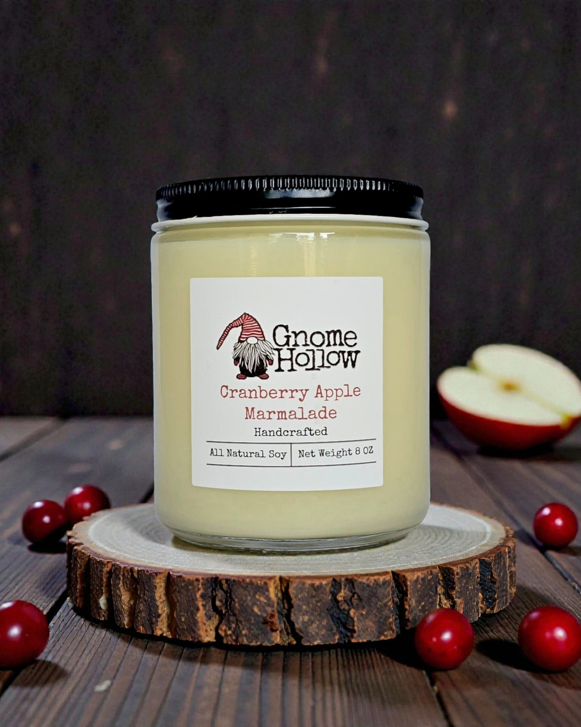 Candle with cranberries & apples sprinkled around