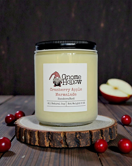 Candle with cranberries & apples sprinkled around