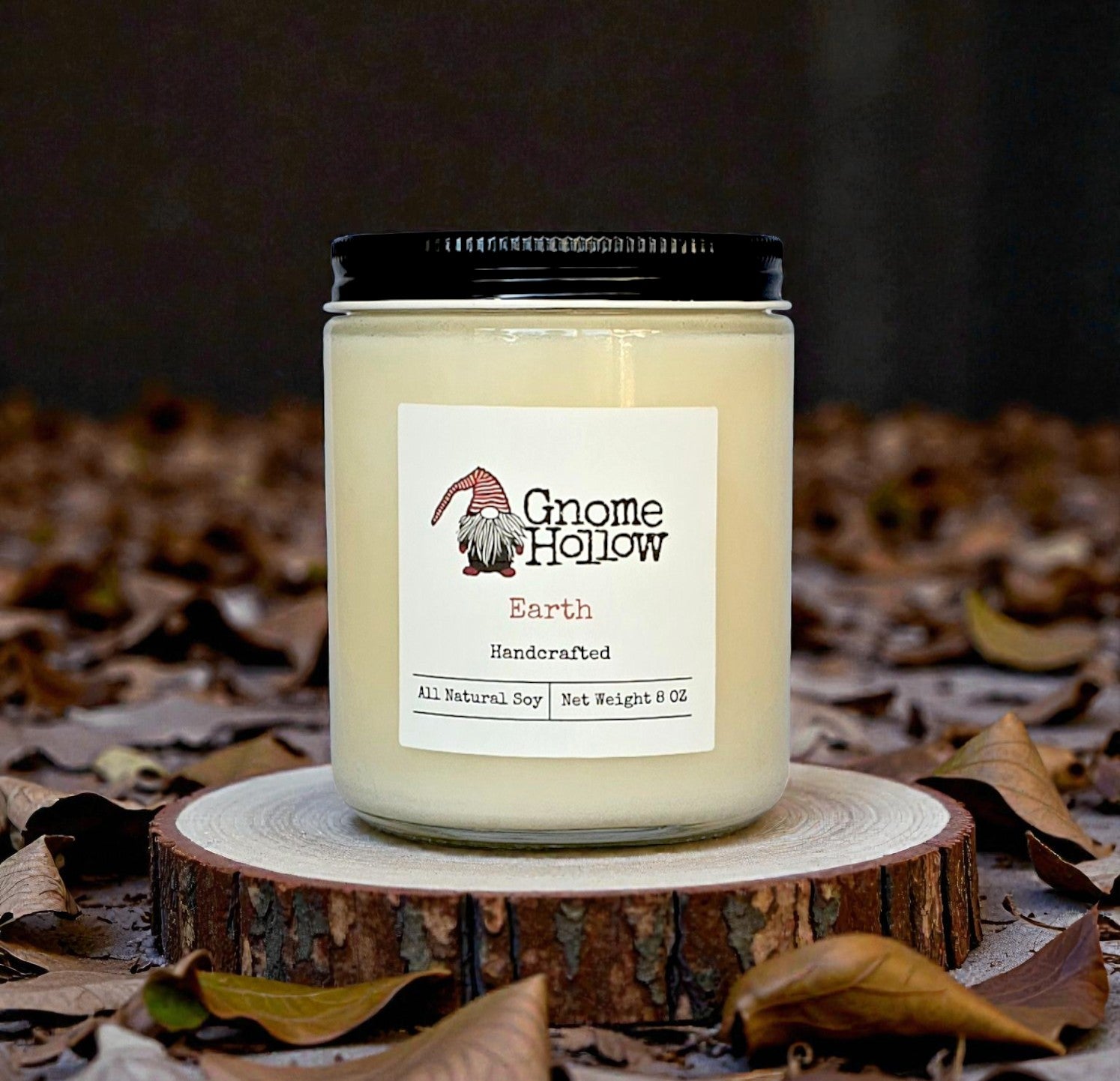 Candle surrounded by leaves