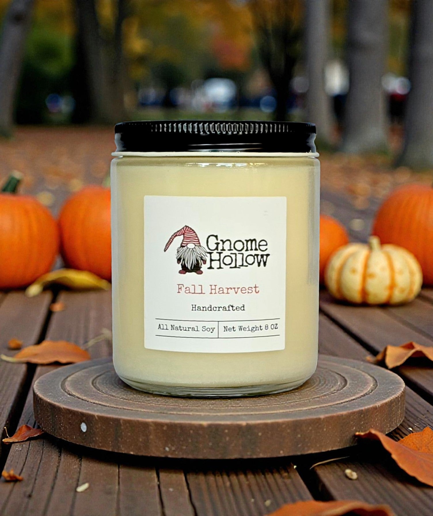 Candle in front of pumpkins