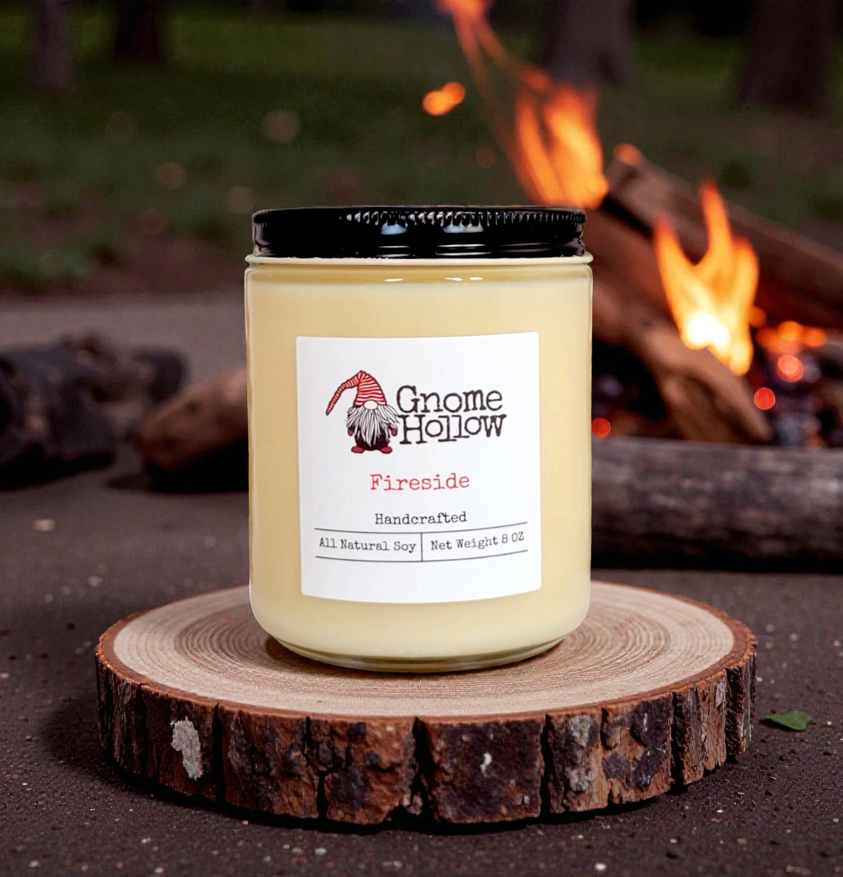 Candle on a wood piece with a campfire in the background