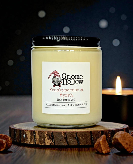 Candle with a lit candle behind it