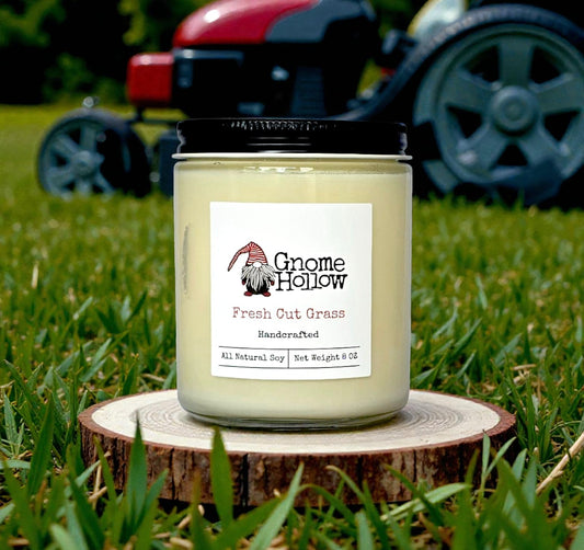 Candle sitting in grass