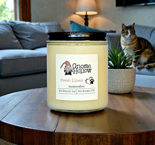Candle with a cat on a couch in the background