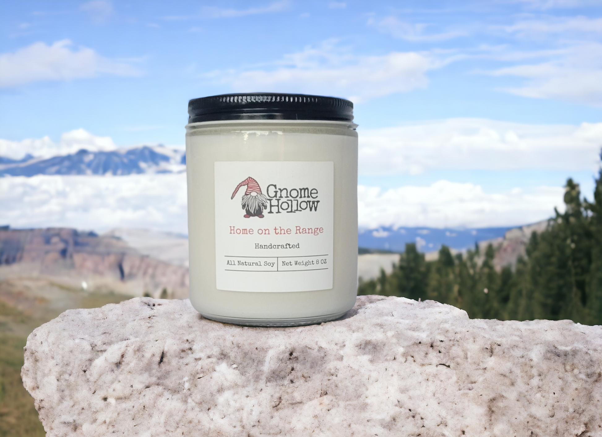 Home on the Range candle with mountains & forest blurred in the background