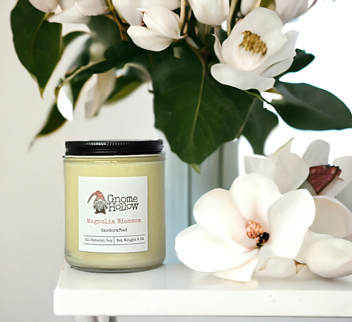 Magnolia Blossom candle with magnolia in the background