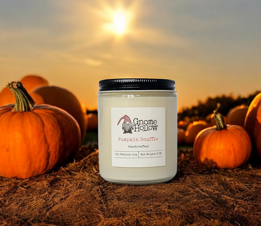 Gnome Hollow Pumpkin Souffle candle in a field of pumpkins with a sunset background