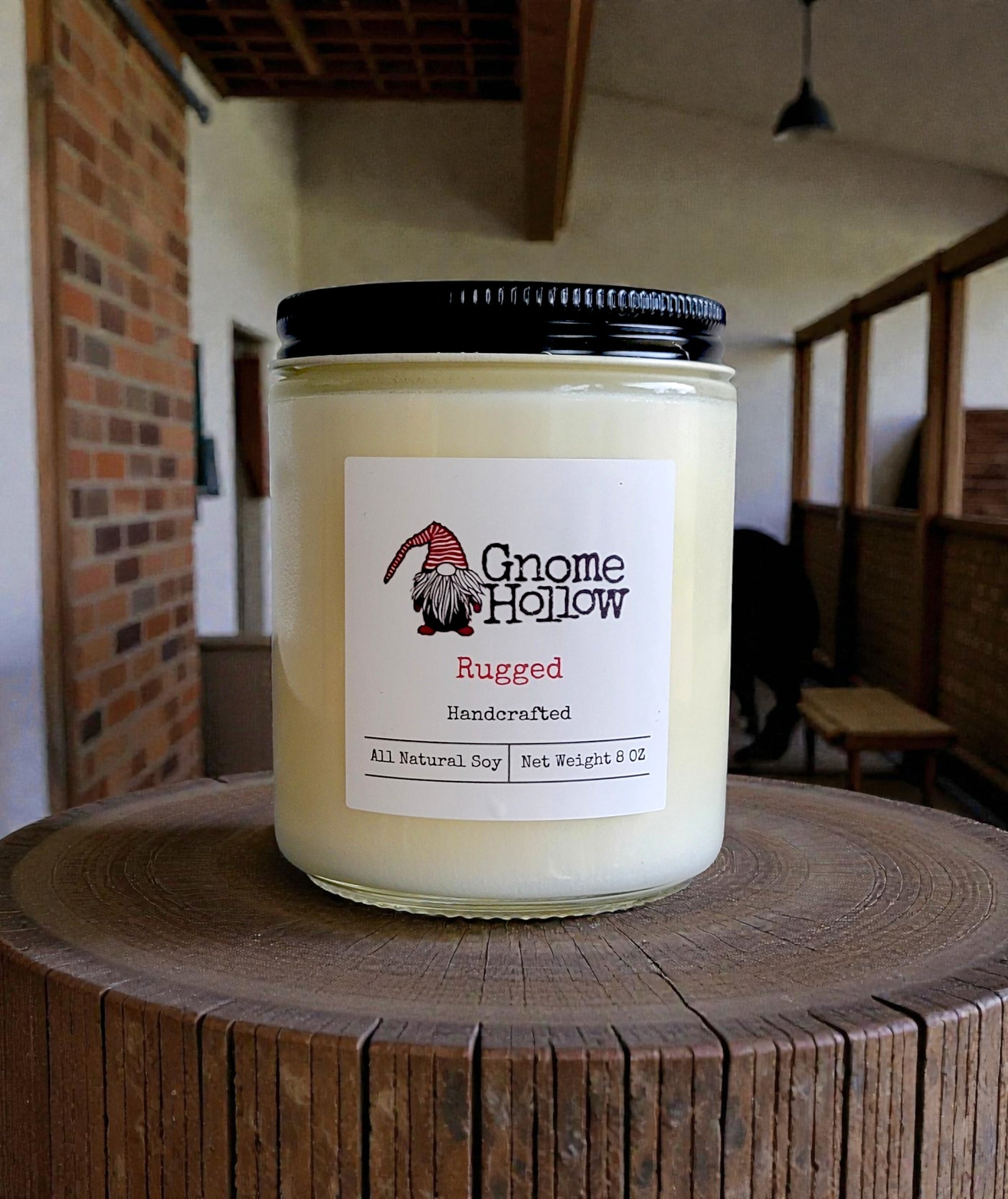 Candle with a tack room in the background