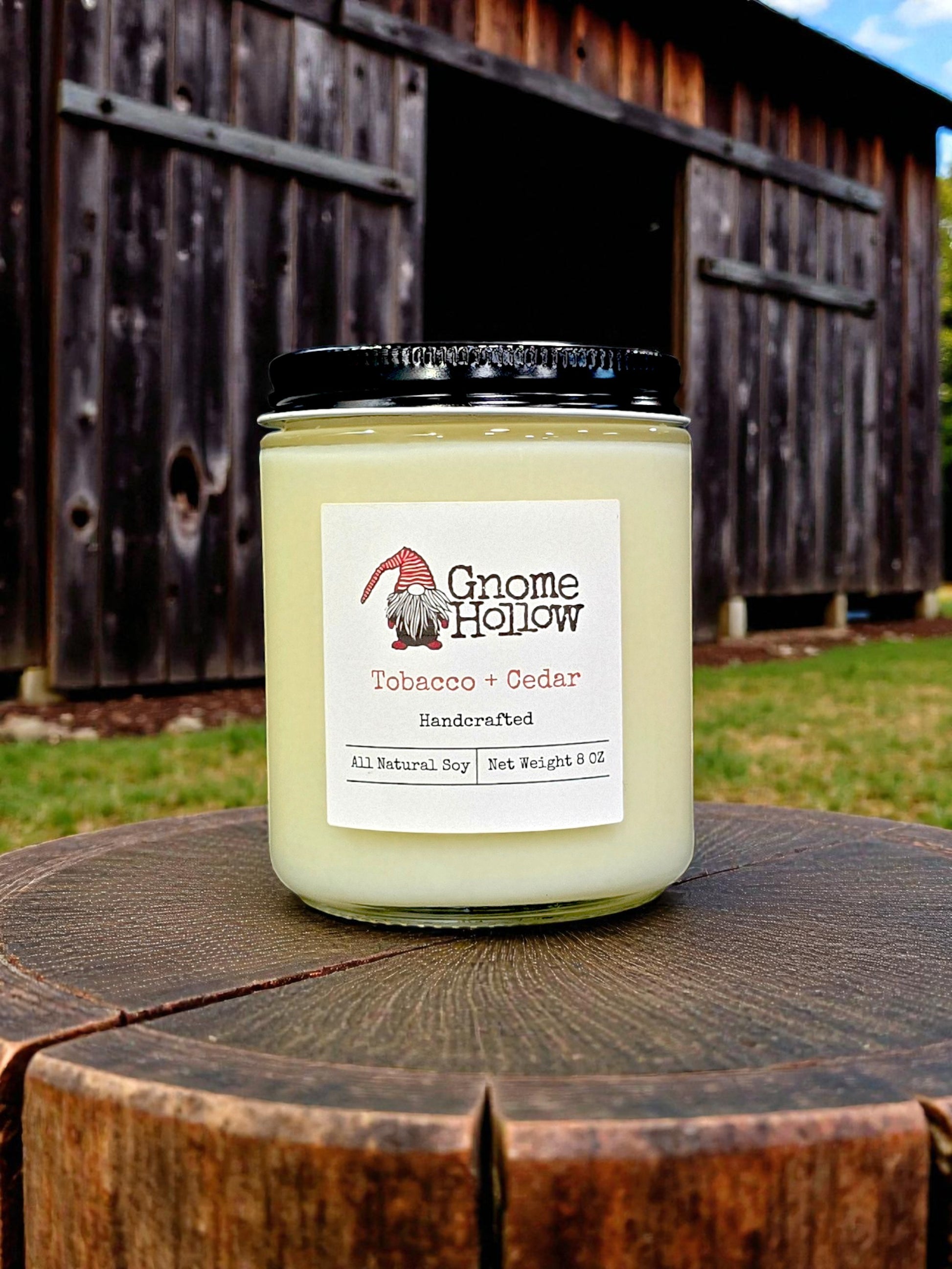 Candle in front of a tobacco barn