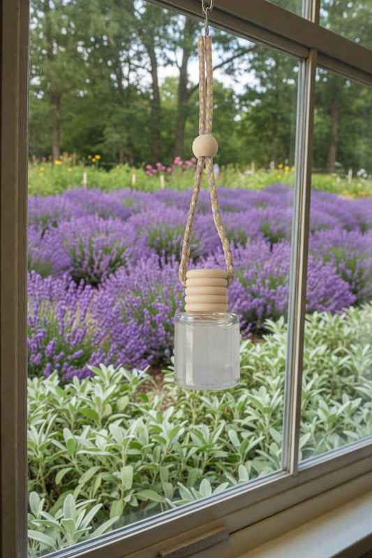 Decorative hanging item in front of a window with a view of a herb garden outside