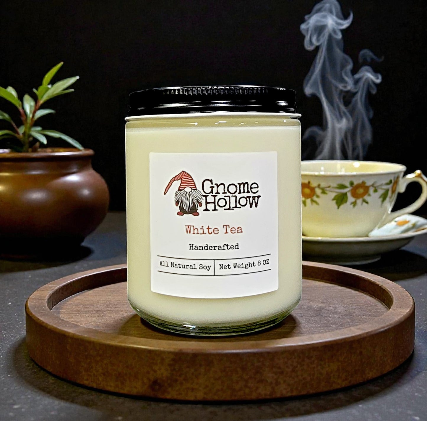 Candle with tea in the background