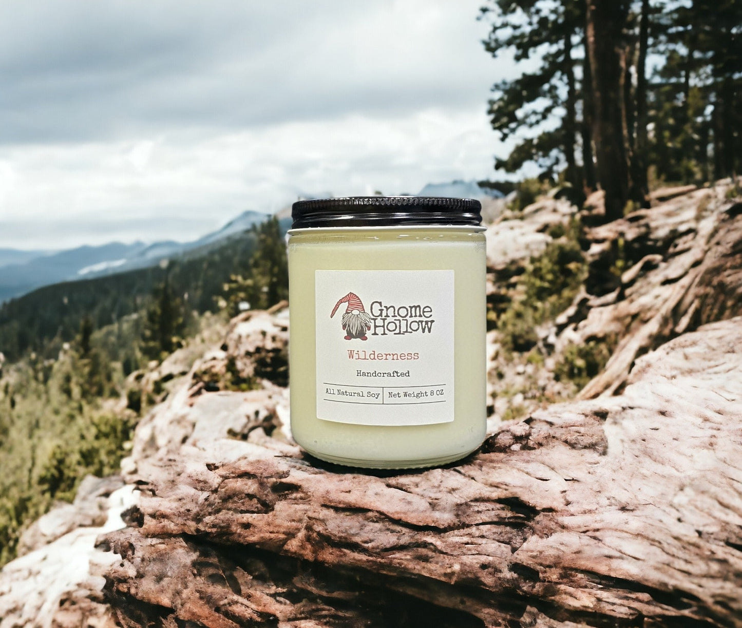 Wilderness candle sitting on a mountain with a blurred backdrop